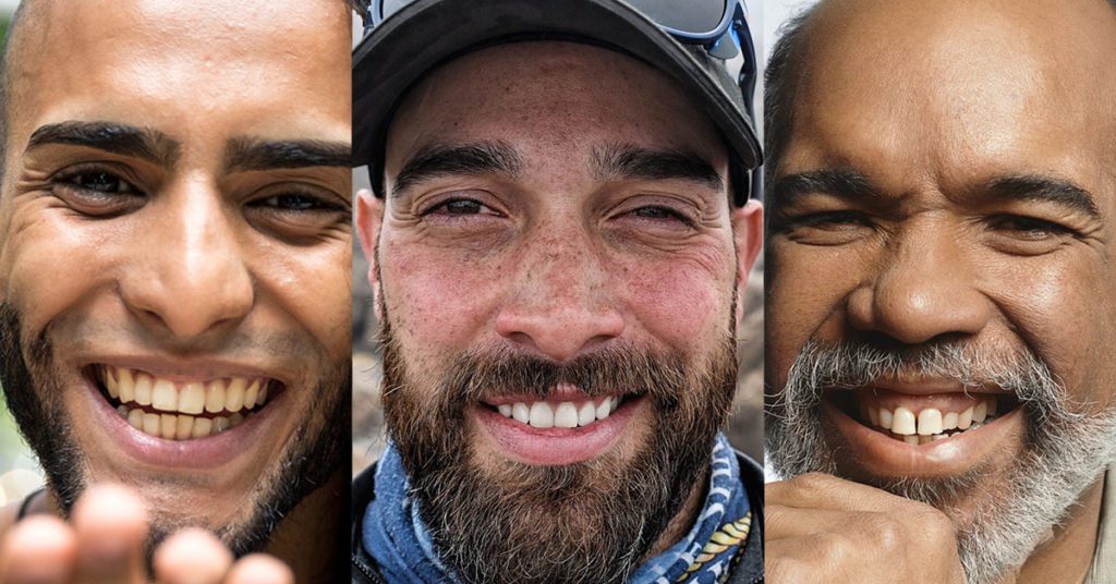 three faces in closeup: a Latinx, African-American, and a White Guy. all three have beards and large toothy smiles.